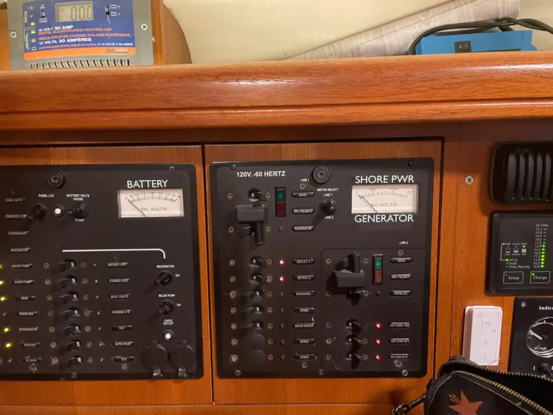 Slide: The Image of Control panel of a 2006 Hunter 38 sailboat, featuring battery and generator switches. - 6