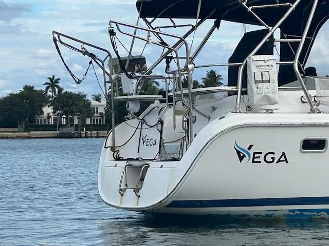 Slide: The Image of 2006 Hunter 38 sailboat docked, featuring sleek design and protective fenders. - 8