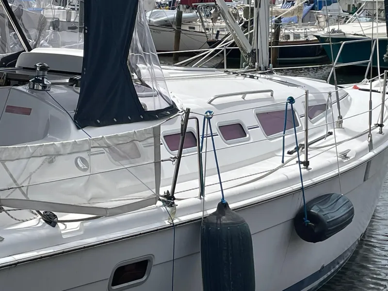 Slide: The Image of Hunter 38 sailboat from 2006 docked, featuring sleek white hull and "Vega" branding. - 9