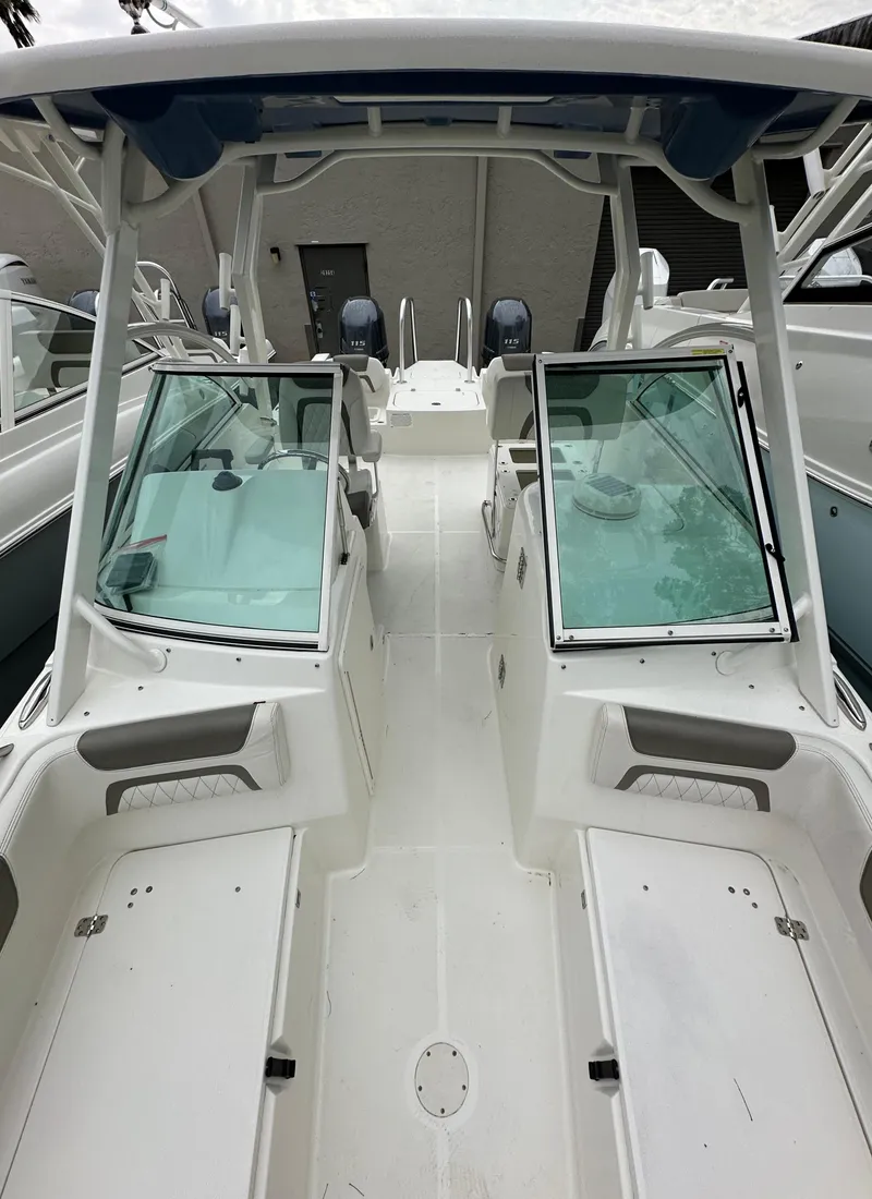 Slide: The Image of 2021 World Cat 230 DC boat interior with dual consoles and seating. - 6