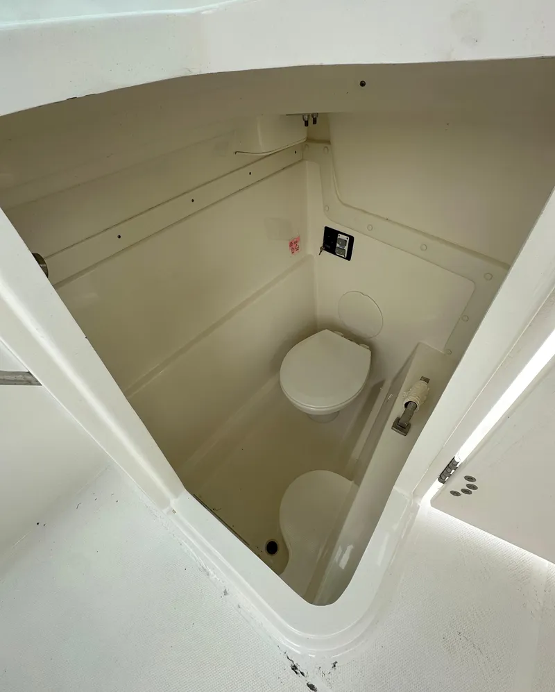 Slide: The Image of 2021 World Cat 230 DC boat interior with compact marine toilet. - 7