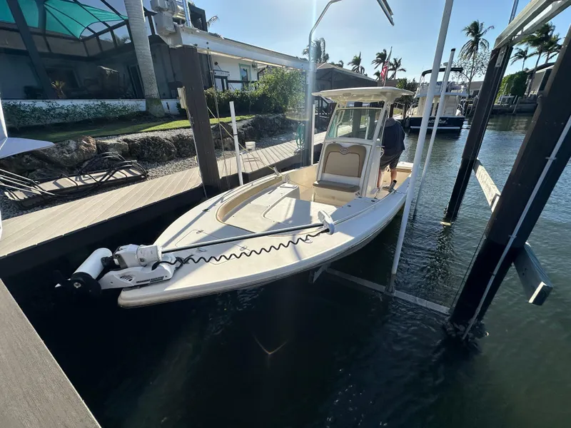 Slide: The Image of 2017 Scout 251 XS boat docked in a marina, featuring a sleek design and modern equipment. - 1