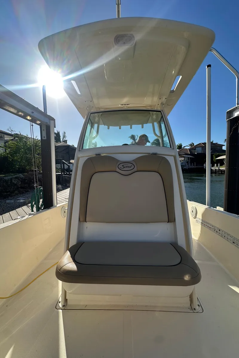 Slide: The Image of 2017 Scout 251 XS boat with seating, docked under sunny skies. - 10