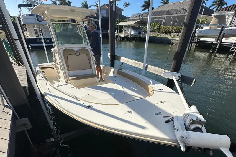Slide: The Image of 2017 Scout 251 XS boat docked in a marina, featuring a sleek design and spacious deck. - 11