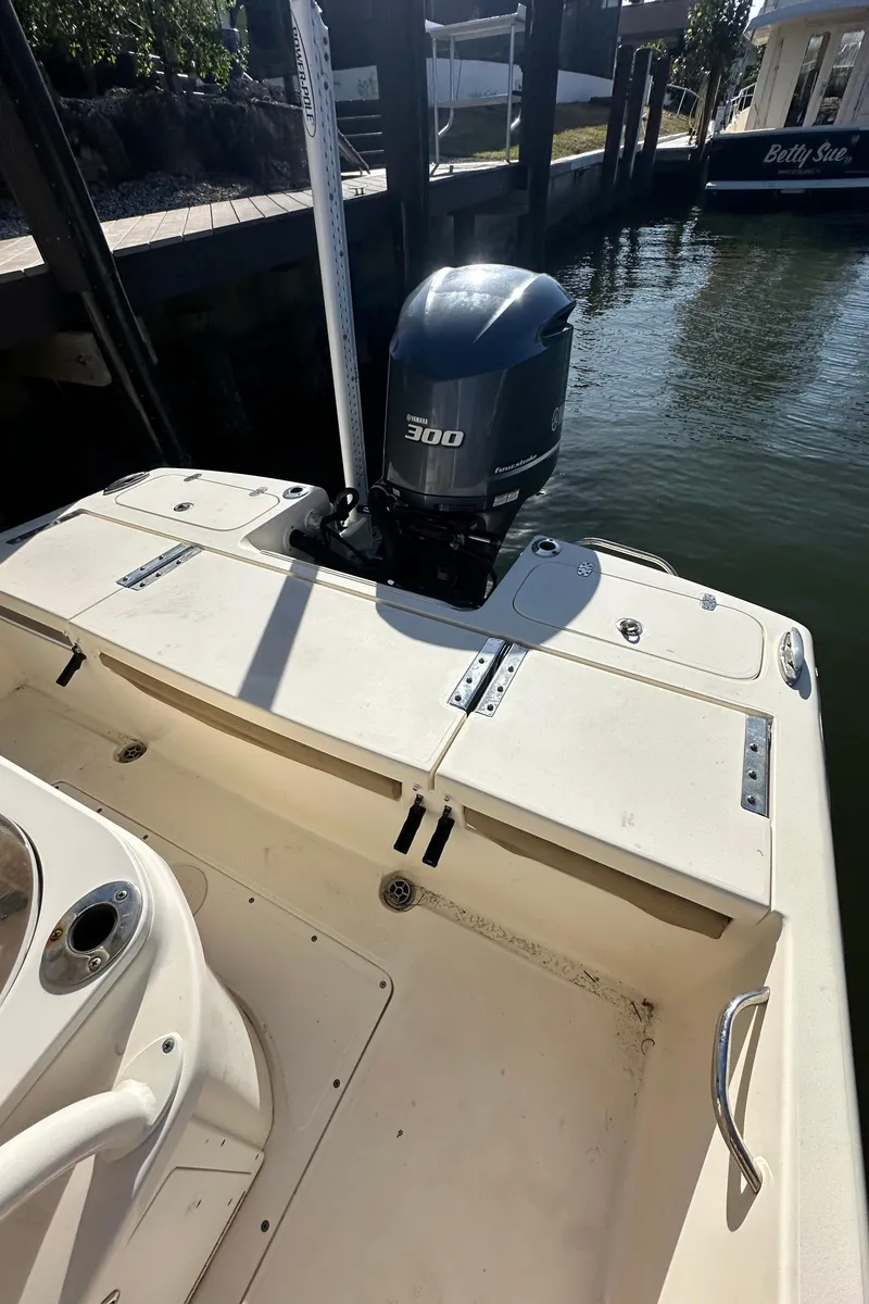 Slide: The Image of 2017 Scout 251 XS boat with 300 HP engine docked by the water. - 4