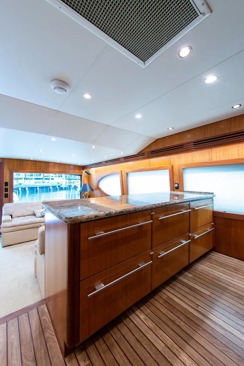 Slide: The Image of Interior of 2006 Hatteras 64 Convertible yacht with wooden cabinetry and modern lighting. - 16