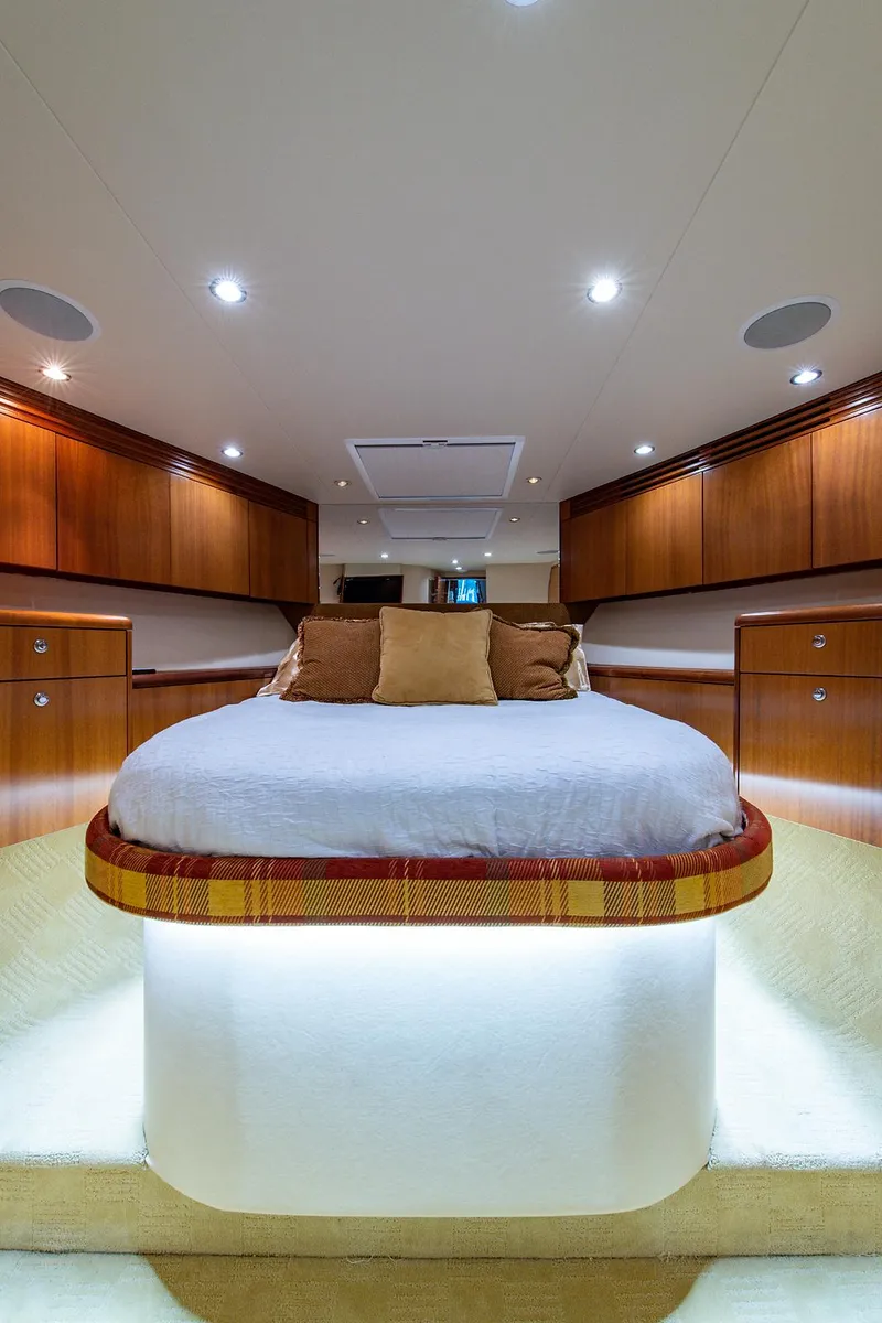 Slide: The Image of Luxurious bedroom interior of 2006 Hatteras 64 Convertible yacht with elegant wood cabinetry. - 26