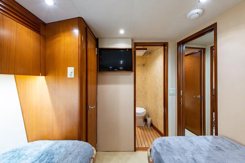 Slide: The Image of Interior of 2006 Hatteras 64 Convertible yacht cabin with twin beds and ensuite bathroom. - 29