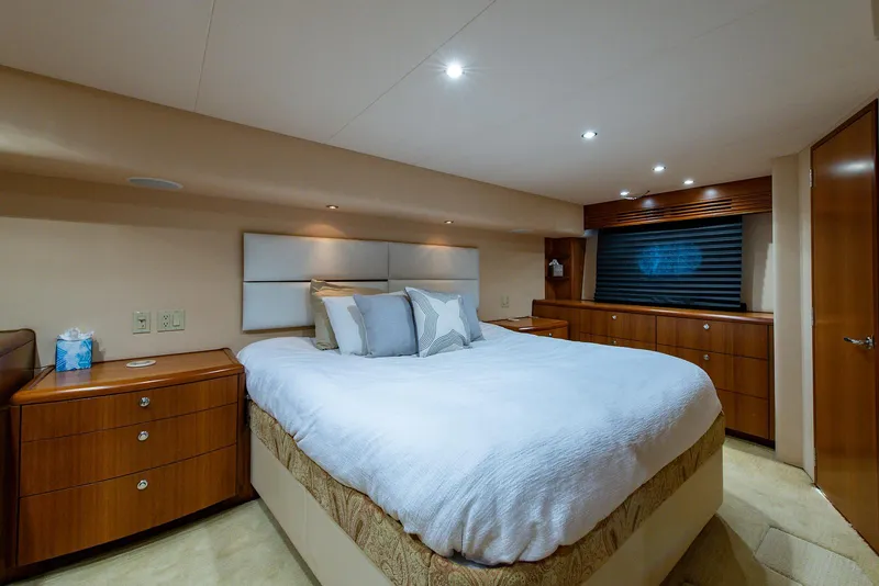 Slide: The Image of Luxurious bedroom interior of 2006 Hatteras 64 Convertible yacht with elegant wood furnishings. - 35