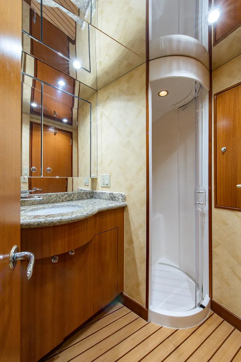 Slide: The Image of Luxurious bathroom in 2006 Hatteras 64 Convertible yacht with modern shower and wooden cabinetry. - 38