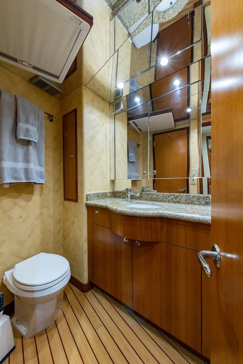 Slide: The Image of Luxurious bathroom in 2006 Hatteras 64 Convertible yacht with wood accents and modern fixtures. - 39