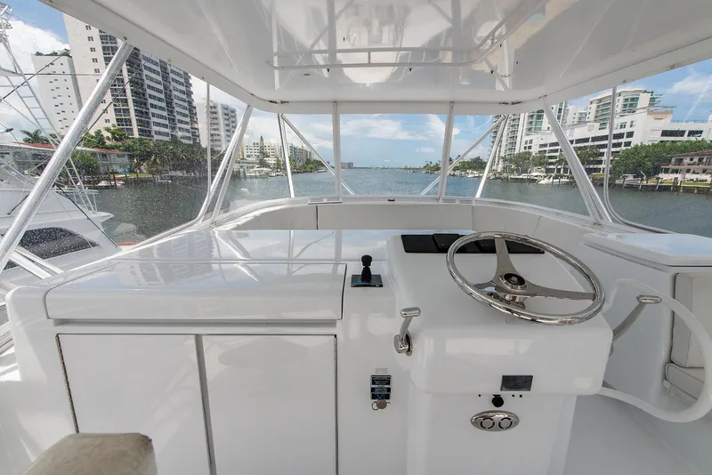 Slide: The Image of 2006 Hatteras 64 Convertible yacht helm with cityscape view. - 40