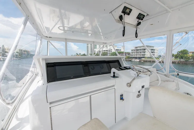 Slide: The Image of 2006 Hatteras 64 Convertible yacht helm with modern controls and waterfront view. - 41
