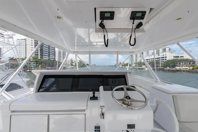 Slide: The Image of 2006 Hatteras 64 Convertible yacht helm with cityscape view. - 42