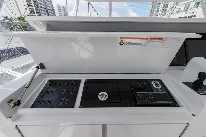 Slide: The Image of Control panel of a 2006 Hatteras 64 Convertible yacht, featuring navigation and system controls. - 43