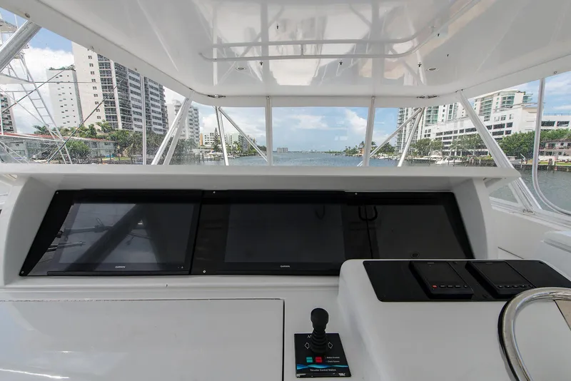 Slide: The Image of Helm of 2006 Hatteras 64 Convertible yacht with cityscape view. - 44