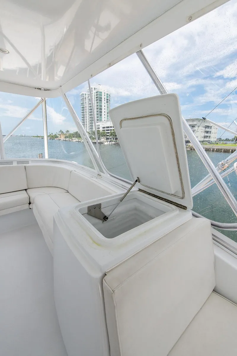 Slide: The Image of 2006 Hatteras 64 Convertible yacht interior with open storage compartment, overlooking waterfront buildings. - 49
