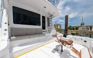 Slide: The Image of 2006 Hatteras 64 Convertible yacht deck with seating and fishing equipment. - 7