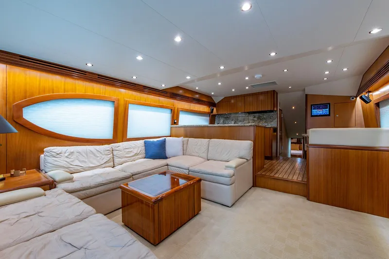 Slide: The Image of Luxurious interior of 2006 Hatteras 64 Convertible yacht with plush seating and wooden accents. - 9