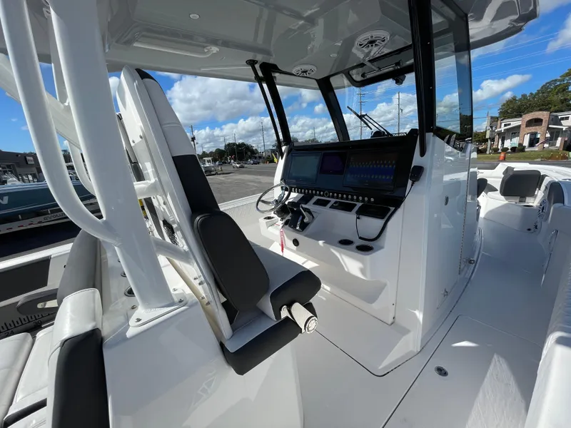Slide: The Image of 2023 Fountain 32 NX boat interior with modern dashboard and seating. - 12