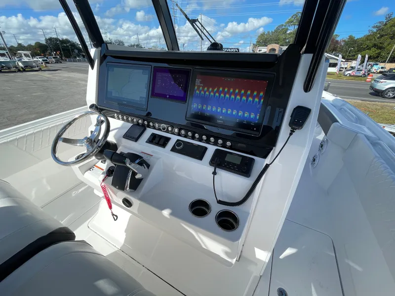 Slide: The Image of 2023 Fountain 32 NX boat dashboard with modern navigation displays and controls. - 14