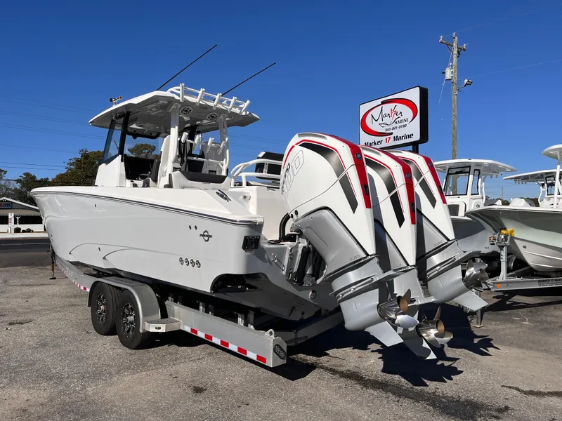 Slide: The Image of 2023 Fountain 32 NX boat on trailer with dual outboard engines. - 3
