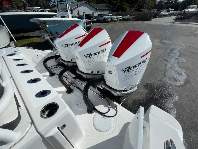 Slide: The Image of Triple outboard engines on a 2023 Fountain 32 NX boat, featuring sleek design and powerful performance. - 6