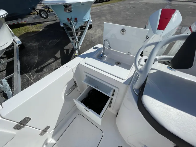 Slide: The Image of 2023 Fountain 32 NX boat interior with sink and storage compartments. - 9