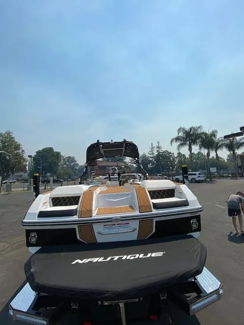 Slide: The Image of 2021 Nautique Super Air Nautique GS24 boat on trailer, outdoor setting. - 11