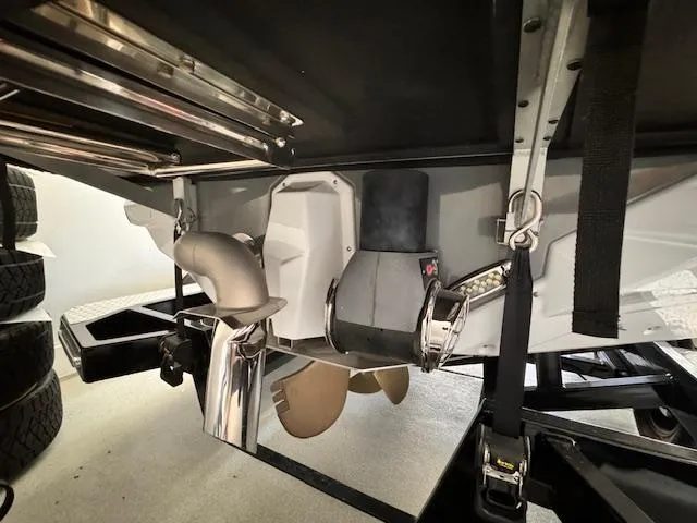 Slide: The Image of 2021 Nautique Super Air Nautique GS24 boat underside, showing propeller and exhaust system. - 16