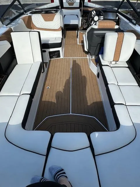 Slide: The Image of 2021 Nautique Super Air Nautique GS24 interior with white and brown seating. - 17