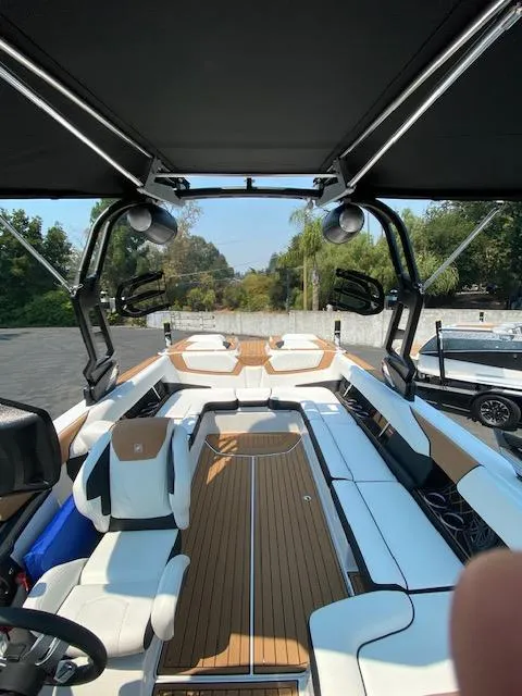 Slide: The Image of 2021 Nautique Super Air Nautique GS24 boat interior with sleek seating and modern design. - 19