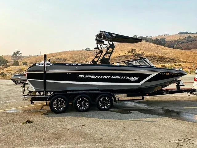 Slide: The Image of 2021 Nautique Super Air Nautique GS24 boat on trailer, parked outdoors. - 2