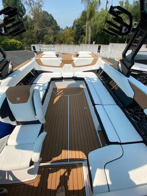 Slide: The Image of 2021 Nautique Super Air Nautique GS24 interior with sleek seating and wood accents. - 20