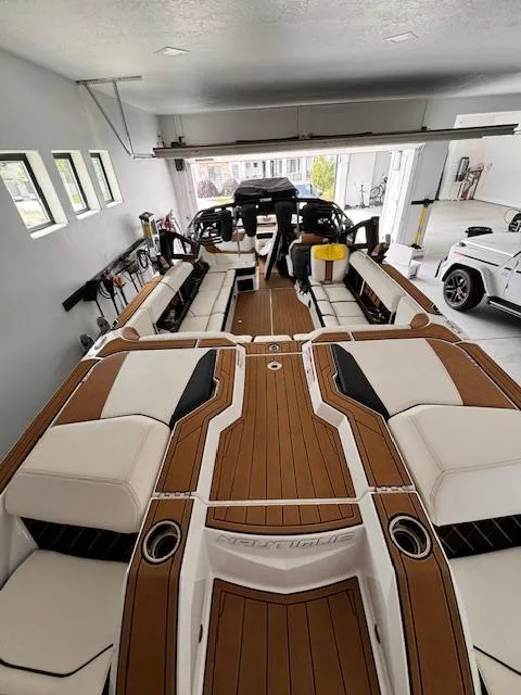 Slide: The Image of 2021 Nautique Super Air Nautique GS24 boat in a garage, showcasing luxurious interior design. - 22