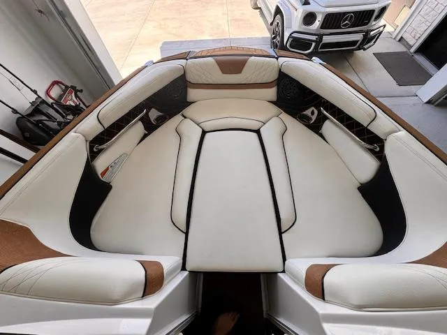 Slide: The Image of 2021 Nautique Super Air Nautique GS24 boat interior with luxurious seating. - 23