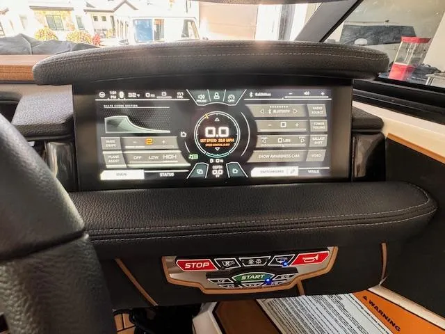 Slide: The Image of 2021 Nautique Super Air Nautique GS24 dashboard with digital display and control buttons. - 42