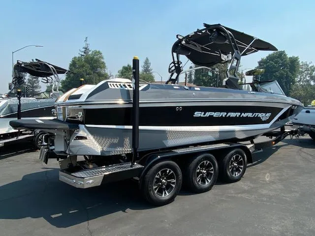 Slide: The Image of 2021 Nautique Super Air Nautique GS24 boat on trailer, parked outdoors. - 6