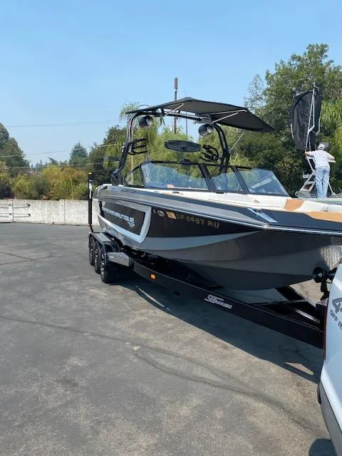 Slide: The Image of 2021 Nautique Super Air Nautique GS24 boat on trailer, parked outdoors. - 7
