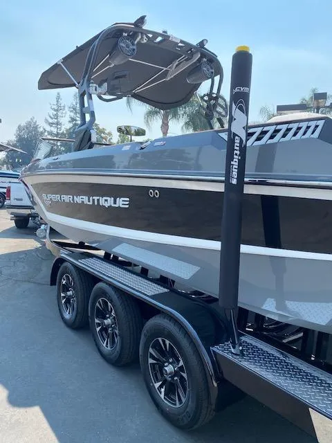 Slide: The Image of 2021 Nautique Super Air Nautique GS24 boat on a trailer, featuring sleek design and modern equipment. - 8