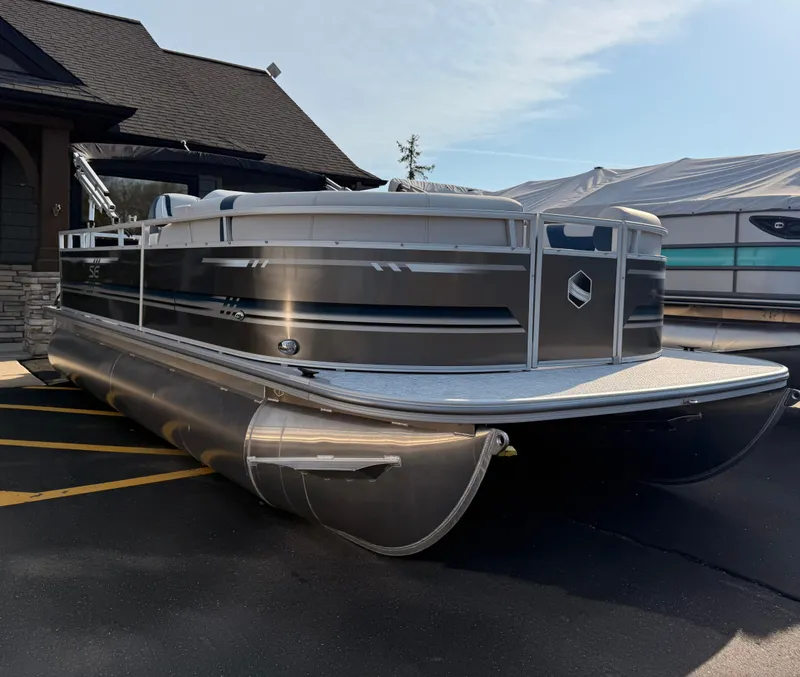 Slide: The Image of 2025 South Bay 20CR SE S pontoon boat parked outdoors. - 1