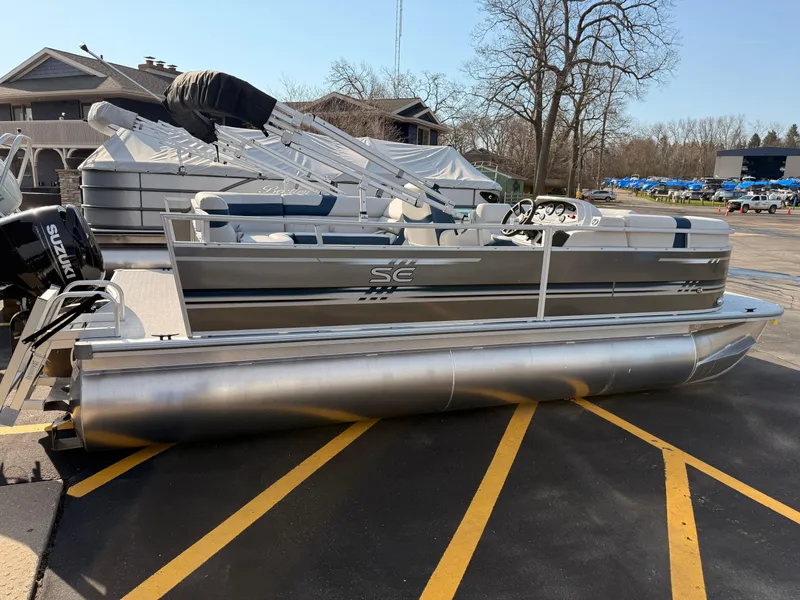 Slide: The Image of 2025 South Bay 20CR SE S pontoon boat parked outdoors on a sunny day. - 16
