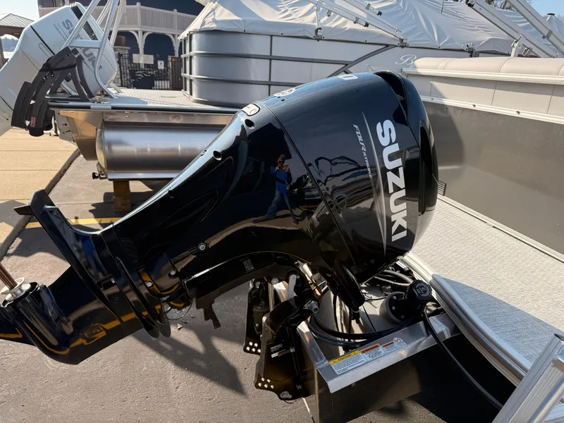 Slide: The Image of 2025 South Bay 20CR SE S pontoon boat with Suzuki outboard motor. - 18