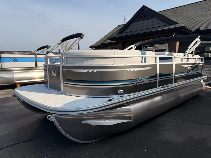 Slide: The Image of 2025 South Bay 20CR SE S pontoon boat parked outdoors. - 2
