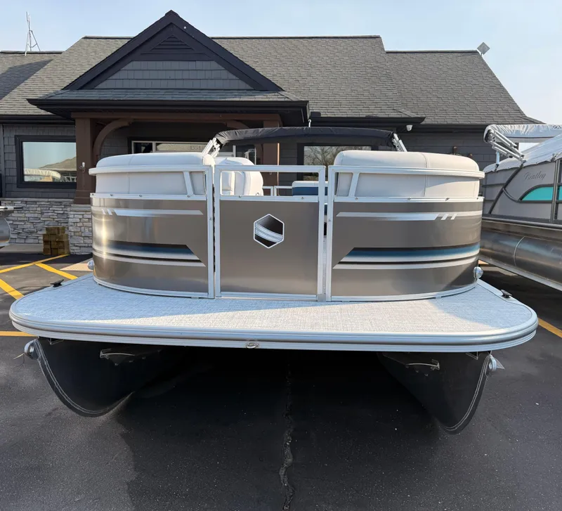 Slide: The Image of 2025 South Bay 20CR SE S pontoon boat parked in front of a building. - 3