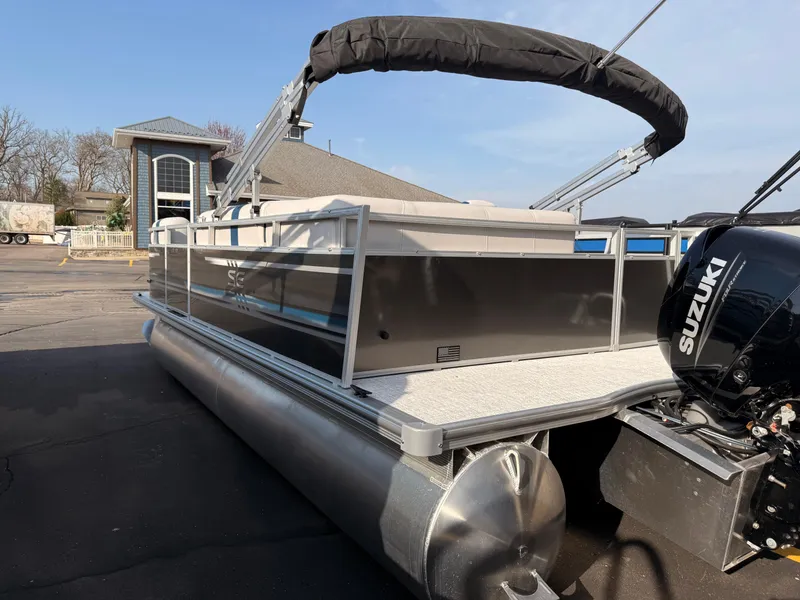 Slide: The Image of 2025 South Bay 20CR SE S pontoon boat with Suzuki engine, docked outdoors. - 4