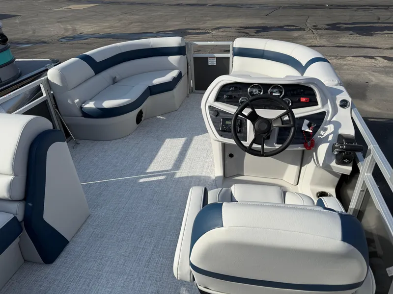 Slide: The Image of 2025 South Bay 20CR SE S pontoon boat interior with steering console and seating. - 8