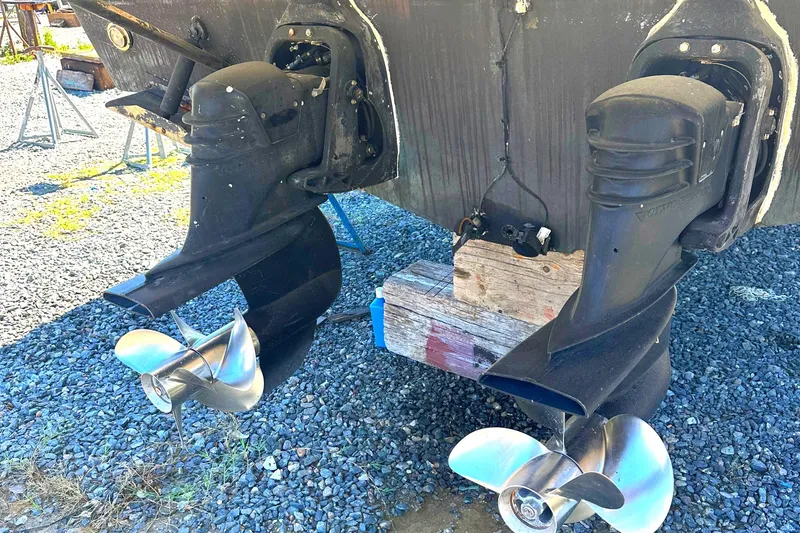 Slide: The Image of 2006 Larson Cabrio 350 boat with dual propellers on gravel surface. - 13