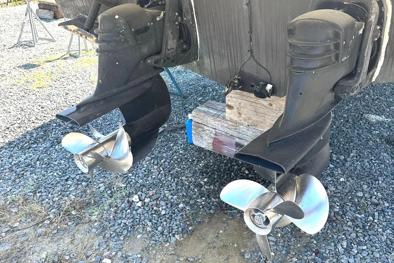 Slide: The Image of 2006 Larson Cabrio 350 boat propellers on gravel surface. - 14