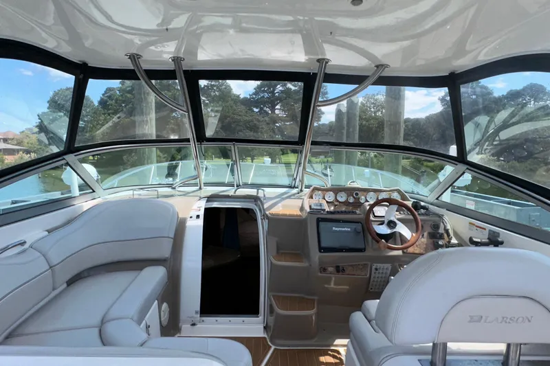 Slide: The Image of Interior view of 2006 Larson Cabrio 350 boat with steering wheel and seating. - 19